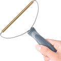 Hair Scraper held, copper edge