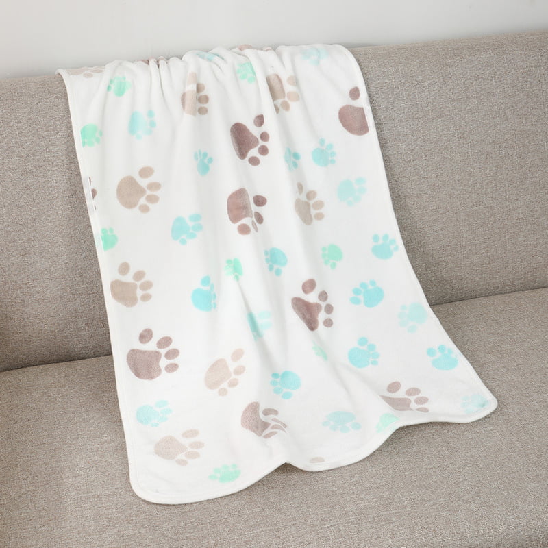 Pet Blanket, white fleece with muted paw prints on a sofa