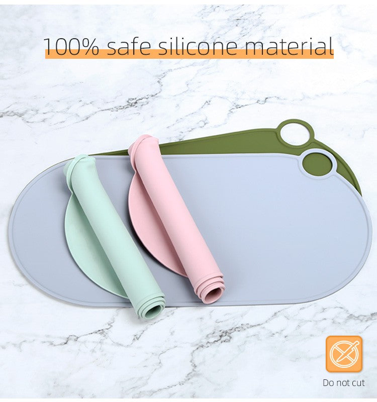 Gray-blue feeding mat with raised edge, two mats rolled beside it