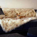 Fur Throw, tan-and-cream shag on a charcoal sofa