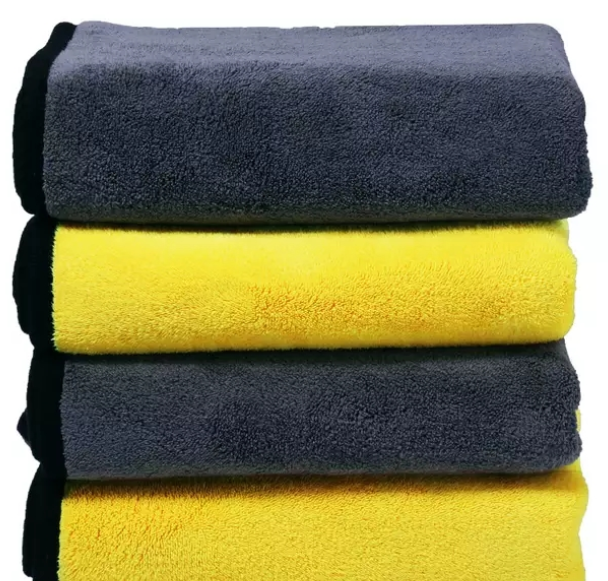 Four folded Dry Towels, yellow and grey, black binding